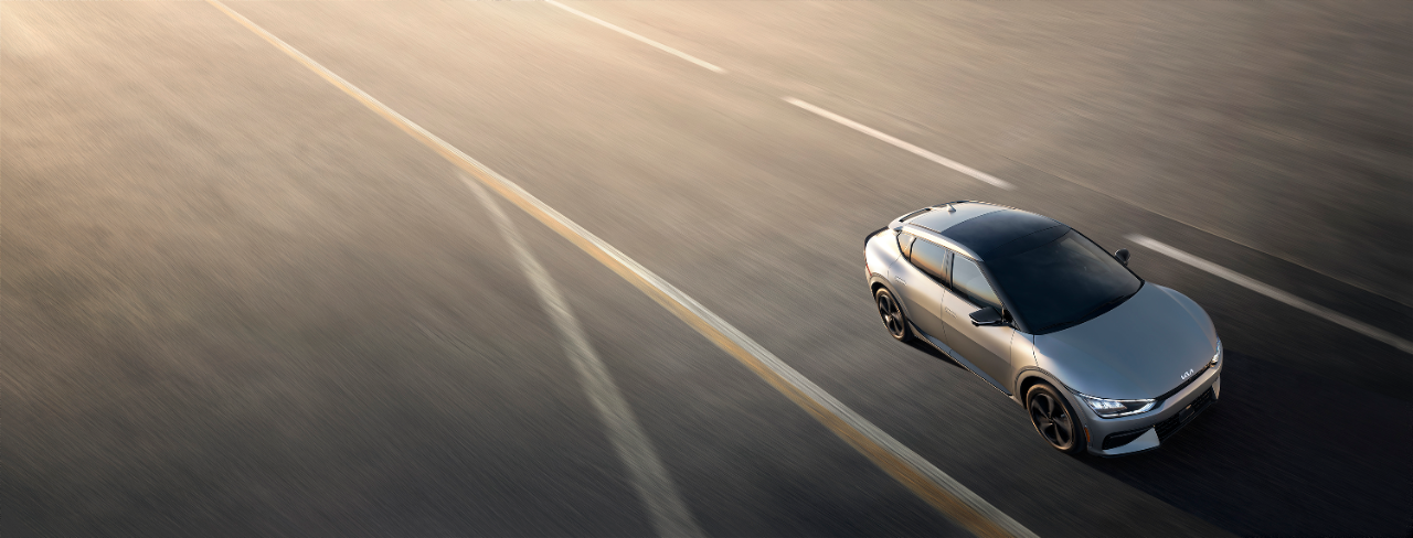 2022 Kia EV6 drives down a wide stretch of road