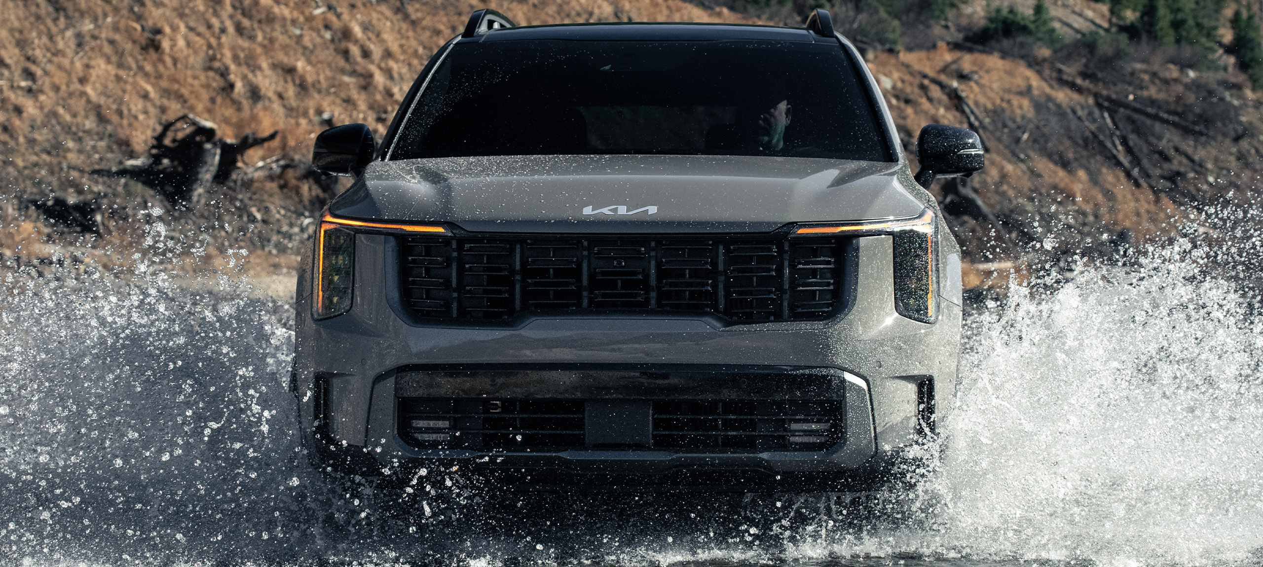 2024 Kia Sorento, front view, driving through water in the mountains making a huge splash