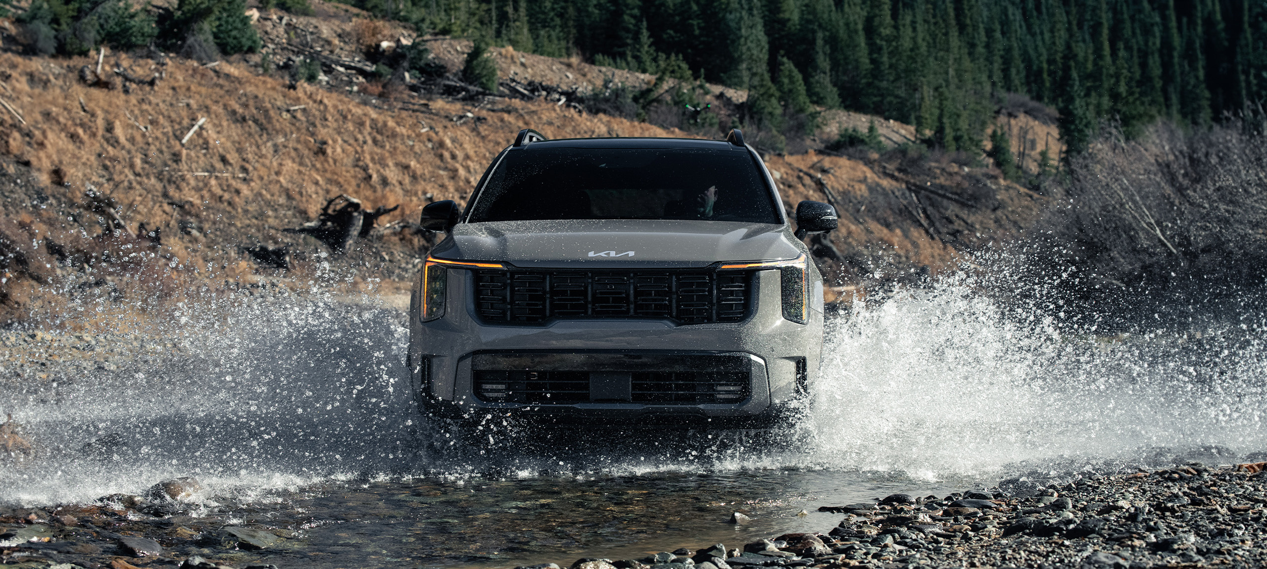 2024 Kia Sorento, front view, driving through water in the mountains making a huge splash